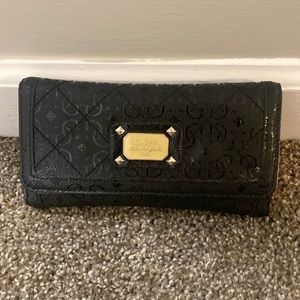 Black Guess wallet. Excelllent condition. Some coin residue in coin pocket